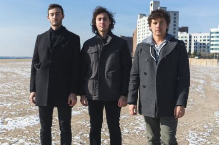 Max Gorelick in left poses for a picture with The Mantle's members.